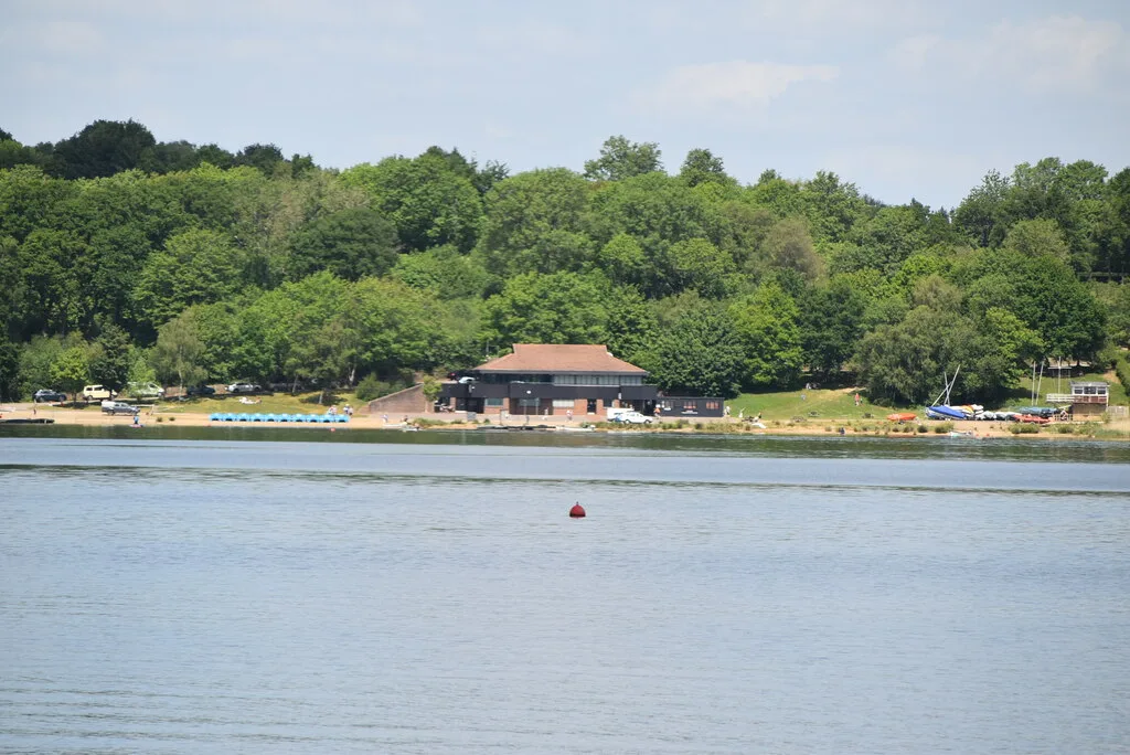 The waterside at Bewl Water, looking across to the sailing club and the pedalos lined up on the shore.
