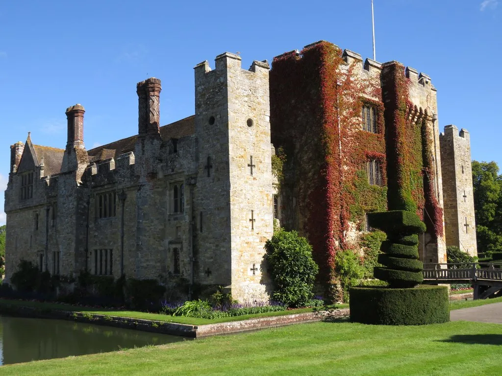 Hever Castle and its moat, with autumn creeper turning red on the castle walls.