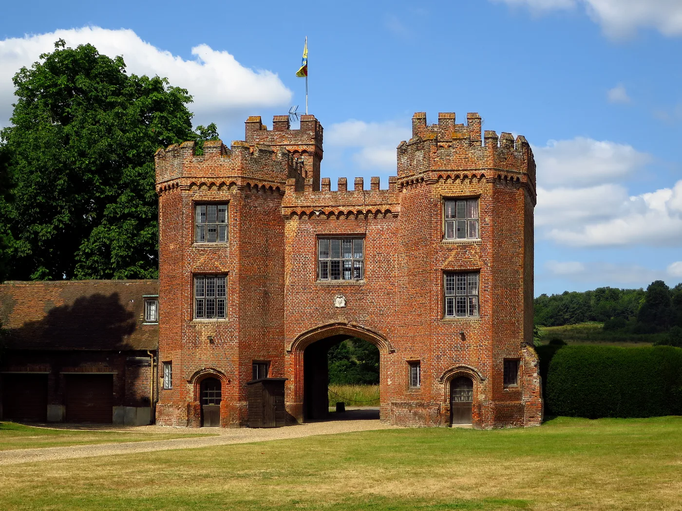 Lullingstone Castle's brick gatehouse, built in 1497. Visitors park just outside it, and the World Garden lies beyond.