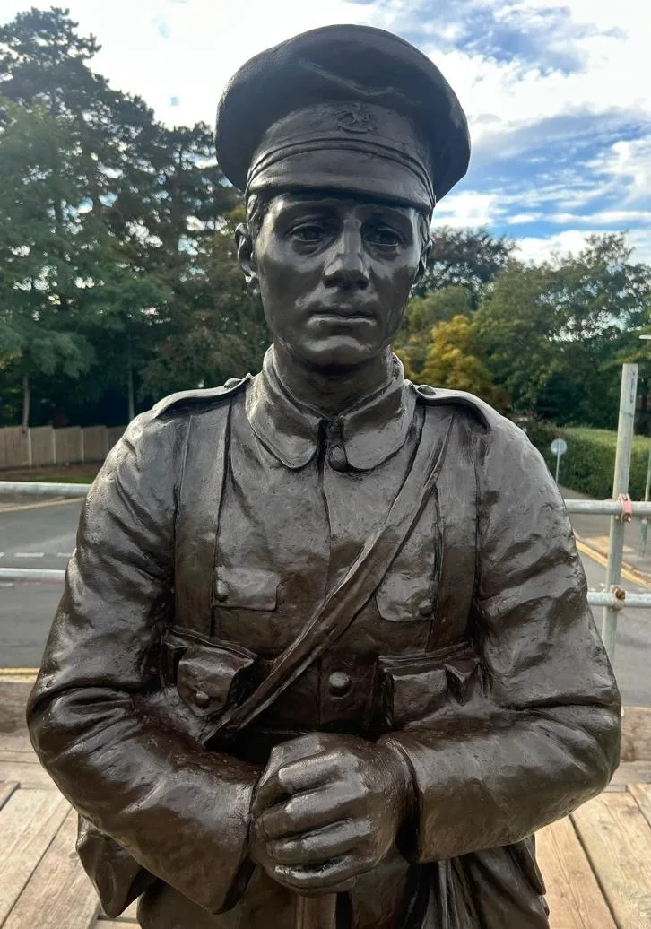 The same bronze soldier after treatment, an even dark brown finish with the cap badge, buttons and pouches clearly defined
